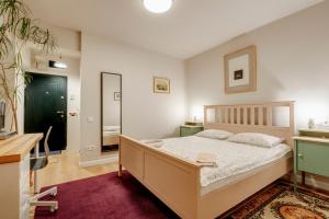 a bedroom with a large bed and a mirror at Cool Opera Apartments in Cluj-Napoca