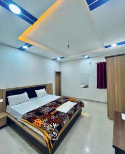 a bedroom with a large bed in a room at Paradise residency and cafe in Gwalior