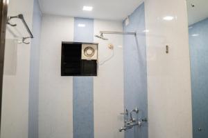 a bathroom with a shower stall with a toilet at Tony's beach house in Calangute