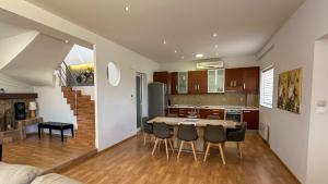 a kitchen and dining room with a table and chairs at Grey Haven Luxury Villa in Stérnai