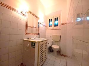 a bathroom with a sink and a toilet and a mirror at GRANDMA BAY HOUSE in São Martinho do Porto +21 photos