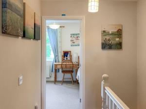 a hallway with a door leading to a room at Middle Cottage in Thirsk