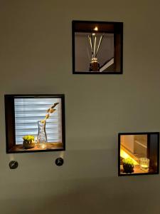 a wall with two mirrors and a window with a vase at LIVE-IN Tiny Studiowohnung in Wertheim