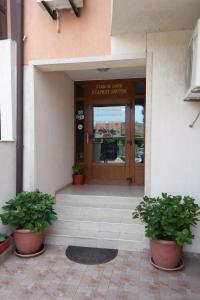 a front door of a building with two potted plants at Guest Hous Stariat kesten in Nesebar +24 photos