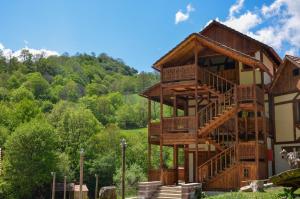 a tree house with a spiral staircase at Ecokayan Dilijan Resort Hotel in Dilijan