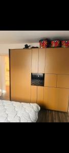 a large wooden dresser in a room with a bed at A very cosy apartment in Bucharest +11 photos