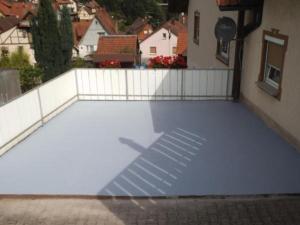 a view of a patio with a fence and a building at Ferienwohnung Kirchblick - b51898 in Langenbrand