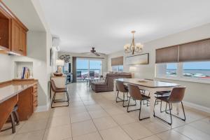 a kitchen and dining room with a table and chairs at Regency Towers 808 West in Pensacola Beach