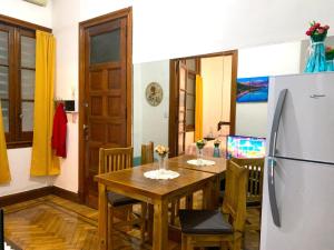 a kitchen and dining room with a table and a refrigerator at Antiguo Maipu in Buenos Aires