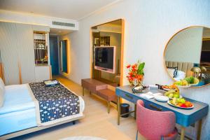 a hotel room with a bed and a table with a mirror at Rocks Hotel & Casino in Kyrenia