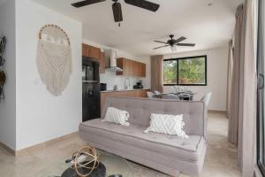 a living room with a couch and a kitchen at 2BD with Rooftop Pool near Beach in Tulum