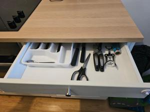 a drawer in a counter with knives and utensils at Spacious 1BR Apartment with Balcony above Citygate Shopping Complex with Metro Access in Vienna