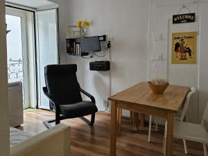a living room with a chair and a wooden table at Window to Lisboa I in Lisbon