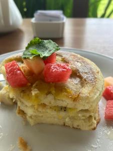 a stack of pancakes with fruit on top on a plate at Lombok Villas, Villa PaoPao in Labuhanpoh