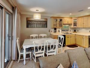 a kitchen and living room with a table and chairs at Inlet Dunes #102 in Inlet Beach