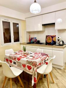 a kitchen with a table with a red and white table cloth at Very nice cosy new appart in Ostwald