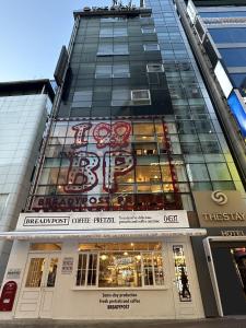 a building with a sign on the side of it at The Stay Hotel Myeongdong in Seoul