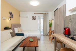 a hotel room with a bed and a couch at Villa Zoi in Paralia Katerinis