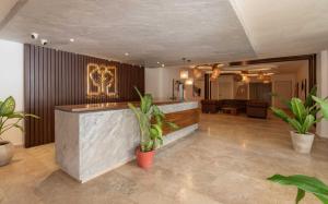 a lobby with potted plants and a bar at 2BD with Rooftop Pool near Beach in Tulum +23 photos