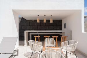 a living room with chairs and a fireplace at 2BD with Rooftop Pool near Beach in Tulum