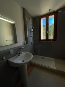 a bathroom with a sink and a shower with a window at Palazzo Durante in Letojanni