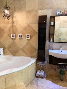 a bathroom with a tub and a sink and a mirror at 7 Saint Andrew in White River