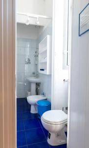 a bathroom with two toilets and a sink at Olympia Hotel in Genoa