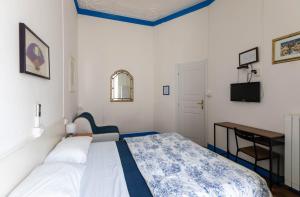 a small bedroom with a bed and a desk at Olympia Hotel in Genoa