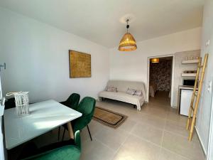 a living room with a table and a couch at Family Villages Santorini in Vlychada Beach