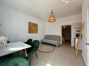 a living room with a table and a couch at Family Villages Santorini in Vlychada Beach