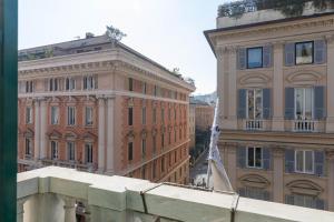 a building with a flag in front of a building at Olympia Hotel in Genoa