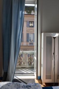a bedroom with a view of a building from a window at Olympia Hotel in Genoa
