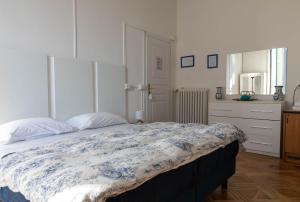 a bedroom with a bed with a blue and white blanket at Olympia Hotel in Genoa