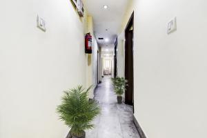 un pasillo con plantas en un edificio blanco en OYO Flagship Hotel Lord Shiva, en Bankipur