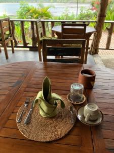 a wooden table with a plate of bananas on it at Lombok Villas, Villa PaoPao in Labuhanpoh