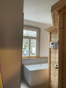 a bath tub in a bathroom with a window at Ferienwohnung am Stockerbach in Freudenstadt