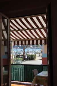 a window view of a patio with a table and chairs at Giulio's terraces in the bay in Le Grazie