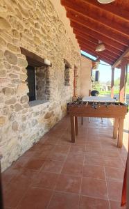 a pool table in a room with a stone wall at El Bierzo Oro en el Camino in Villaverde de la Abadía
