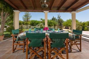 a table and chairs on a patio at Villa Alkis - Spacious Pool Retreat in Zakynthos