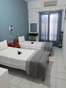 Postel nebo postele na pokoji v ubytování Hotel Theoxenia