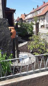 a fence in front of a garden with flowers at Fremdenzimmer Familie Förster in Villingen-Schwenningen