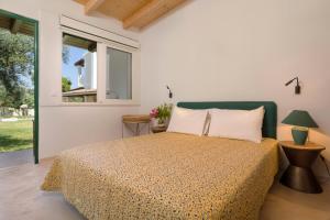 a bedroom with a bed and a window at Villa Alkis - Spacious Pool Retreat in Zakynthos +62 photos
