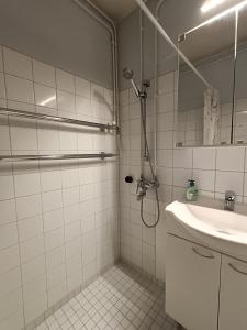 a bathroom with a shower and a sink at Mukkula apartment Lahti 59 m2 in Lahti