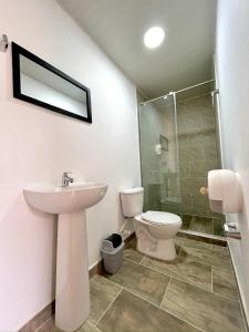 a bathroom with a sink and a toilet and a shower at CASONA HOTEL LA DIVISA in Santa Rosa de Cabal