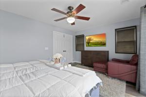 a bedroom with a white bed and a ceiling fan at Three Story Spanish Style 3 Story Home in SD best location in San Diego