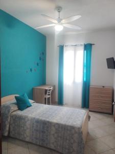 a bedroom with a bed and a ceiling fan at Bed & Breakfast Gli Alisei in Siniscola