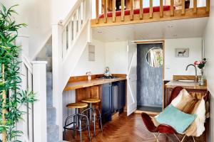 a kitchen with a bar and stools in a house at Extraordinary Huts Ltd in Rye +48 photos