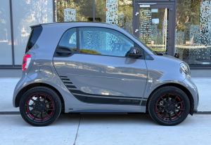 a small silver smart car parked on a sidewalk at Brand New Villa Carmelita Exclusive with free Smart Car in Dubrovnik