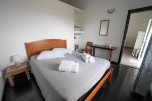 a bedroom with a bed with towels on it at Casa Atlantida - Sea front in Faja Grande