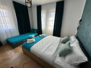 a bedroom with a bed and a bench in it at Miryana Guest House in Ohrid